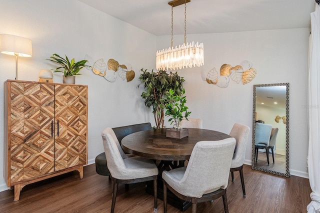 dining room featuring dark hardwood / wood-style floors and an inviting chandelier