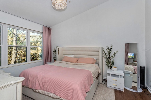 bedroom featuring vaulted ceiling and wood-type flooring