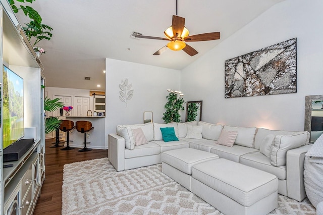 living room featuring lofted ceiling, hardwood / wood-style floors, and ceiling fan