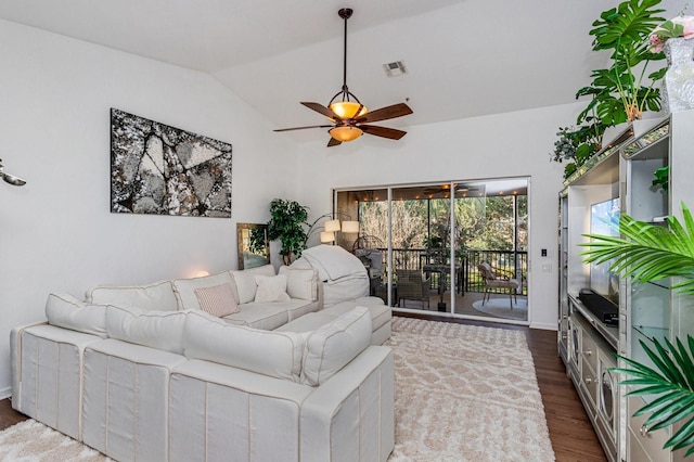 living room with lofted ceiling, dark wood-type flooring, and ceiling fan