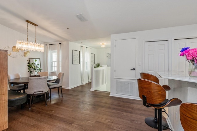 dining space with vaulted ceiling and dark hardwood / wood-style flooring