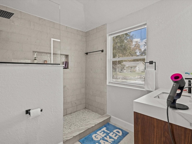 bathroom featuring vanity and a tile shower