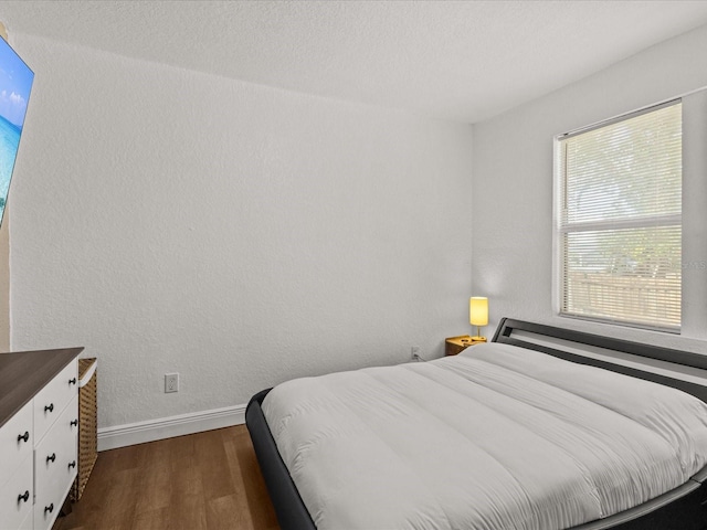 bedroom featuring dark hardwood / wood-style flooring