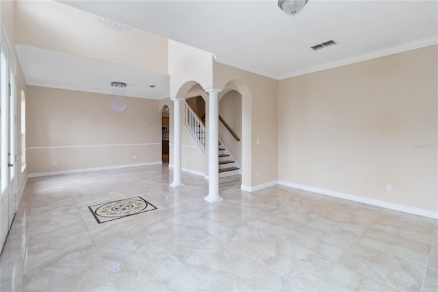 empty room with decorative columns and crown molding