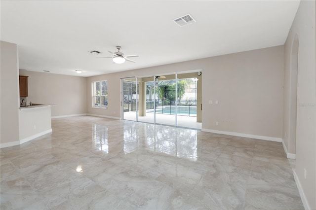 spare room with plenty of natural light and ceiling fan