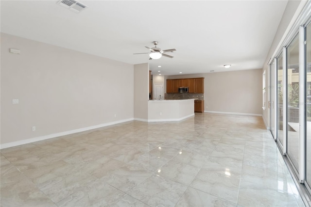 unfurnished living room with ceiling fan