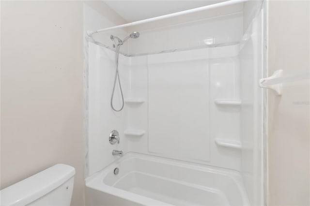 bathroom with shower / washtub combination and toilet