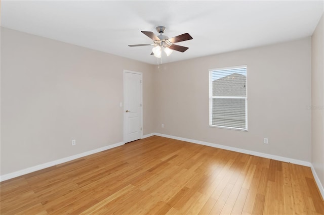 empty room with ceiling fan and light hardwood / wood-style flooring