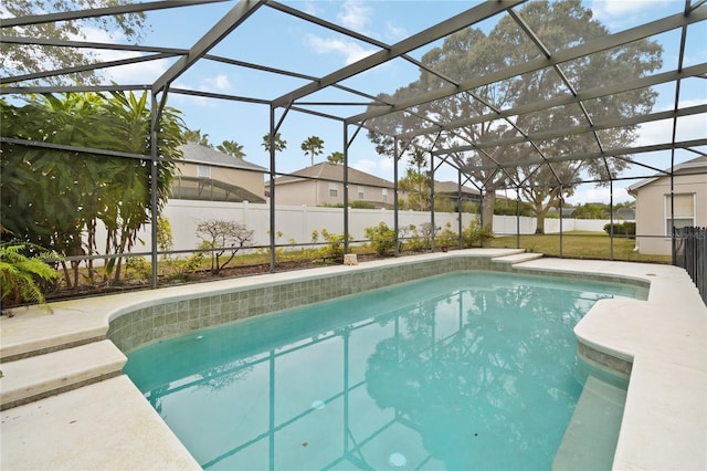 view of swimming pool with a lanai