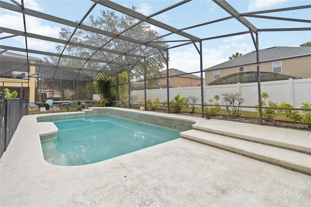 view of swimming pool featuring a patio and glass enclosure