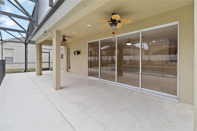 view of patio / terrace with ceiling fan and a lanai