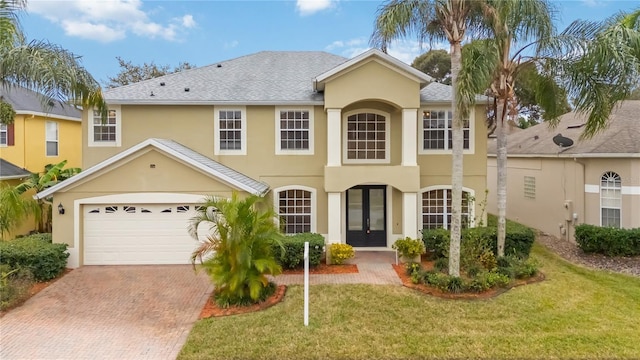 view of front facade featuring french doors, a garage, and a front yard