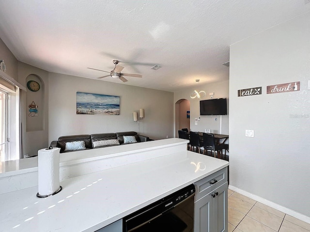 kitchen featuring black dishwasher, gray cabinetry, light tile patterned floors, ceiling fan, and a textured ceiling