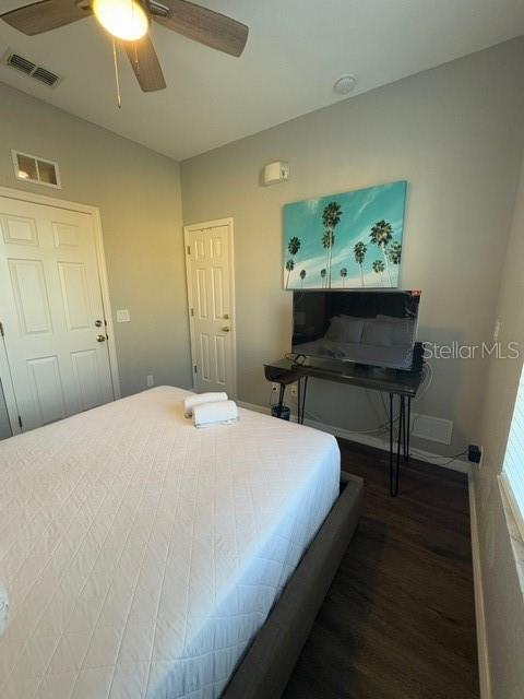 bedroom featuring dark hardwood / wood-style flooring and ceiling fan