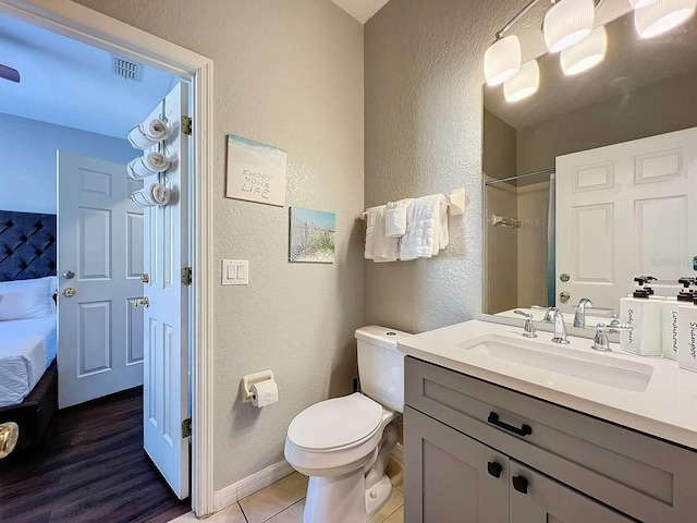 bathroom with vanity, a shower, tile patterned floors, and toilet