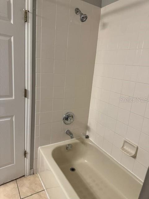 bathroom featuring tile patterned flooring and tiled shower / bath