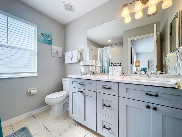 bathroom featuring vanity, a shower with curtain, tile patterned floors, and toilet