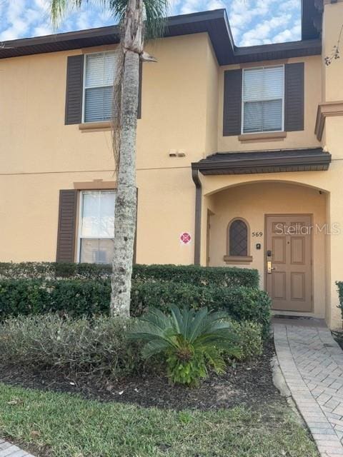 doorway to property with stucco siding