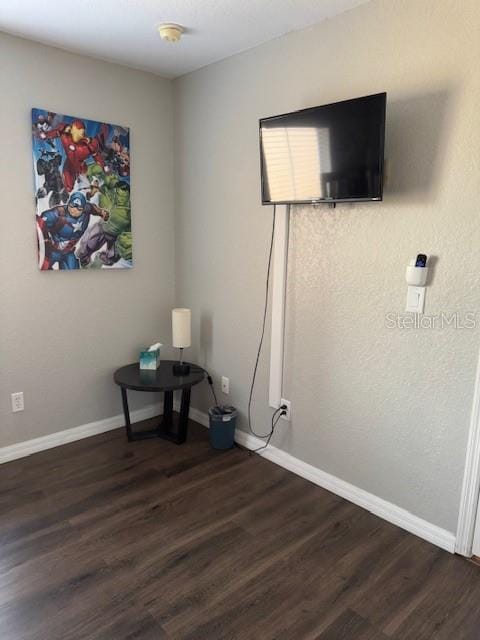 interior space with dark wood-style floors and baseboards