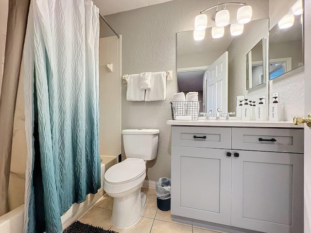 bathroom featuring toilet, a textured wall, tile patterned floors, vanity, and shower / bathtub combination with curtain