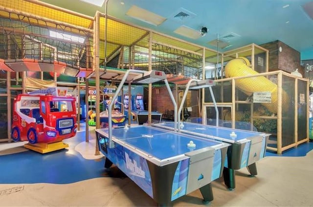 recreation room featuring visible vents and concrete flooring