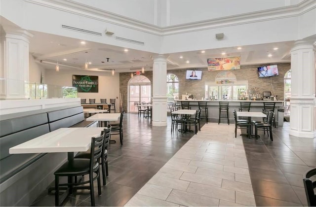 dining room featuring dark tile patterned floors, recessed lighting, and ornate columns