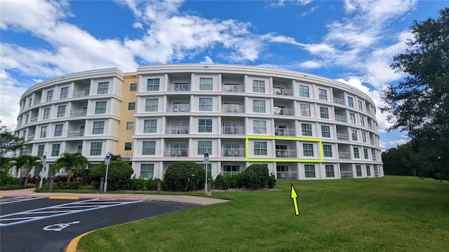 view of building exterior featuring uncovered parking