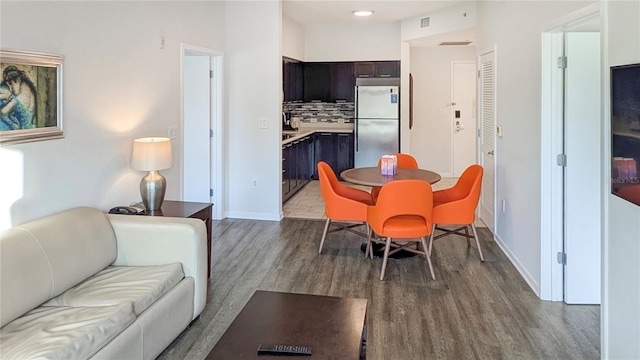 dining room featuring visible vents, baseboards, and wood finished floors