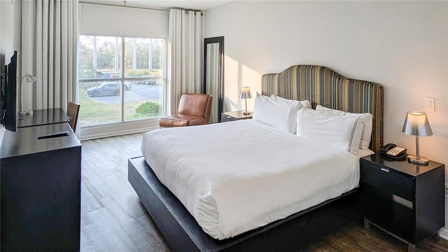 bedroom with dark wood-style floors