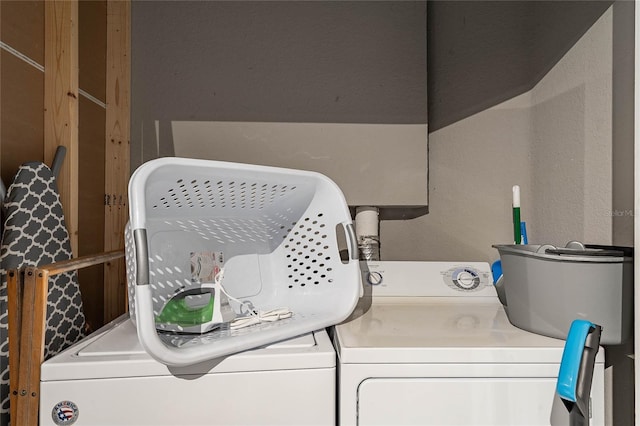 clothes washing area featuring laundry area and washing machine and clothes dryer