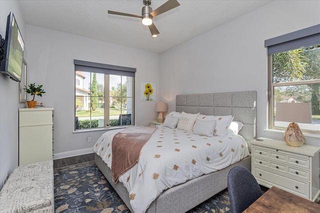 bedroom featuring a textured ceiling, dark wood-type flooring, and ceiling fan