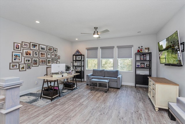 home office featuring ceiling fan, a textured ceiling, and light wood-type flooring