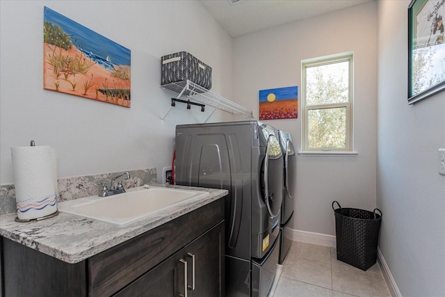 washroom with cabinets, sink, light tile patterned floors, and independent washer and dryer