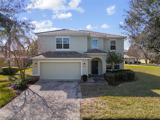 view of front of house with a garage and a front yard