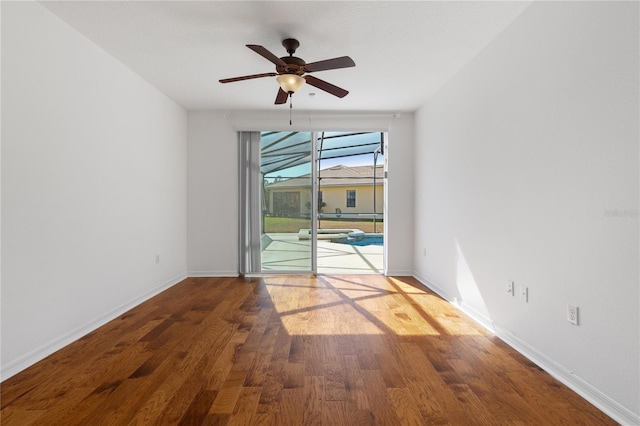 empty room with hardwood / wood-style flooring and ceiling fan