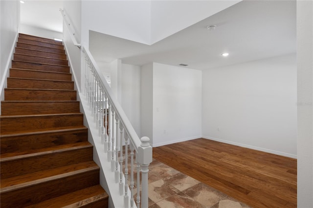 staircase with wood-type flooring