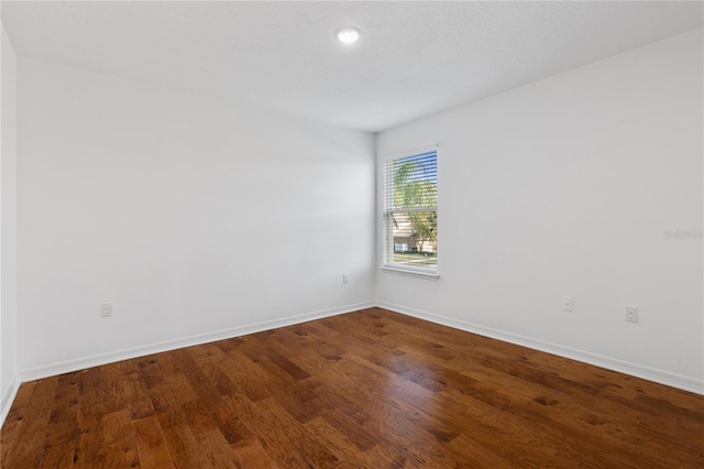 unfurnished room with hardwood / wood-style floors