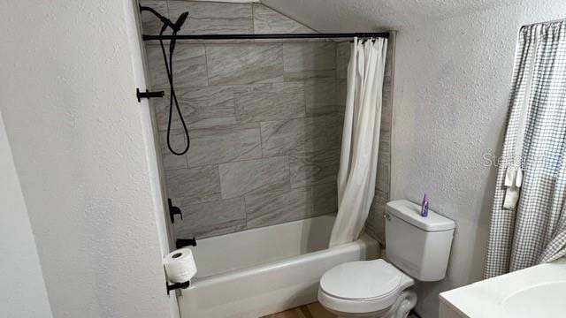 bathroom with shower / bath combo and toilet