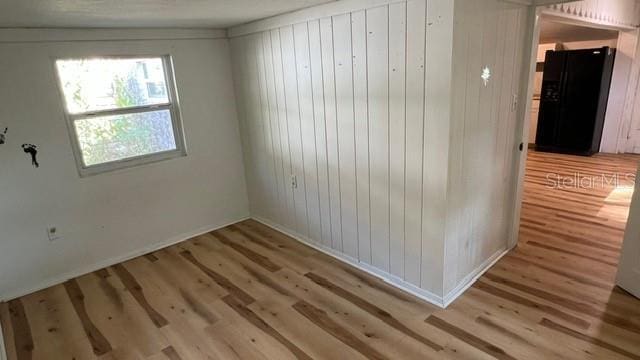 unfurnished room with light wood-type flooring