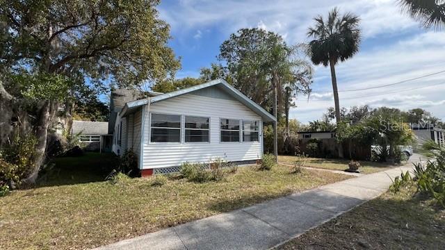 view of side of property with a yard