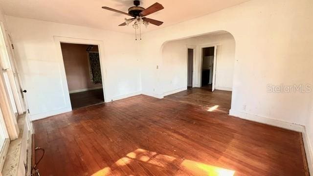 spare room with dark hardwood / wood-style floors and ceiling fan