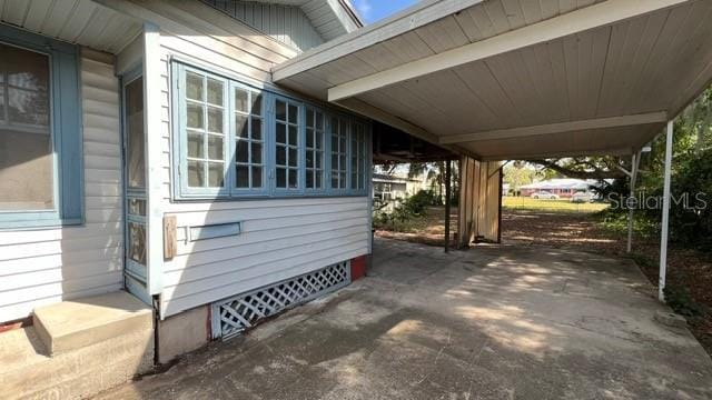 view of home's exterior featuring a carport