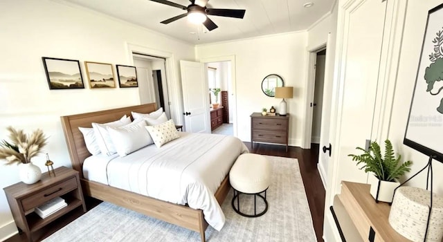 214 N New Hampshire Ave, Tavares, FL 32778 - bedroom with dark wood-style flooring, crown molding, and connected bathroom