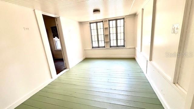214 N New Hampshire Ave, Tavares, FL 32778 - empty room with hardwood / wood-style floors and baseboards