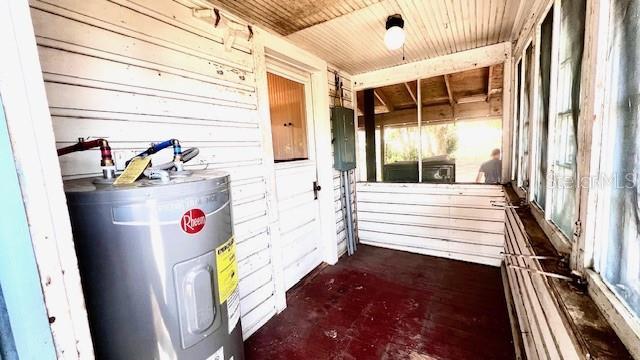 214 N New Hampshire Ave, Tavares, FL 32778 - unfurnished sunroom with water heater, electric panel, and healthy amount of natural light