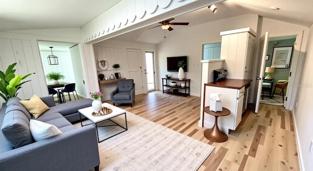 214 N New Hampshire Ave, Tavares, FL 32778 - living area featuring vaulted ceiling, light wood-style flooring, and a ceiling fan