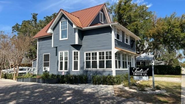 214 N New Hampshire Ave, Tavares, FL 32778 - view of home's exterior featuring metal roof