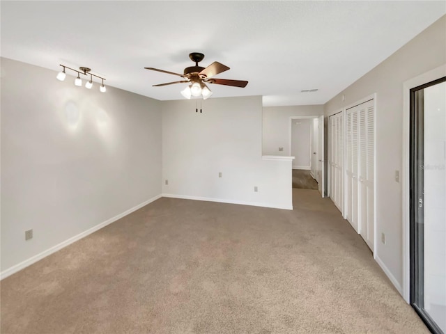 carpeted empty room with ceiling fan