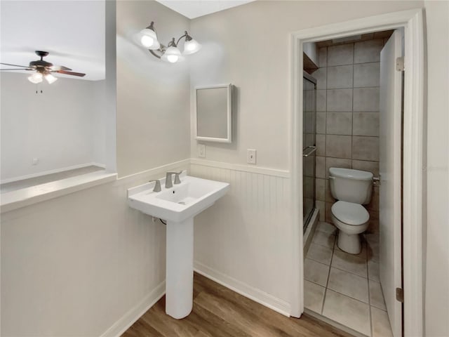 bathroom with ceiling fan, toilet, and hardwood / wood-style floors