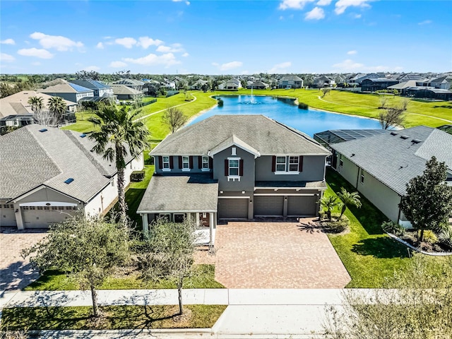 drone / aerial view featuring a residential view and a water view